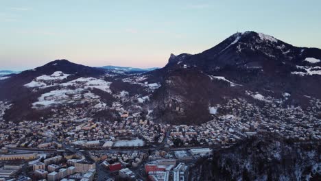 Stunning-winter-wonderland-city-landscape-in-Salzburg,-Austria,-aerial-view