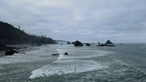 Flyover-of-waves-on-the-rocky-Indian-Beach-in-Oregon-on-an-overcast-day