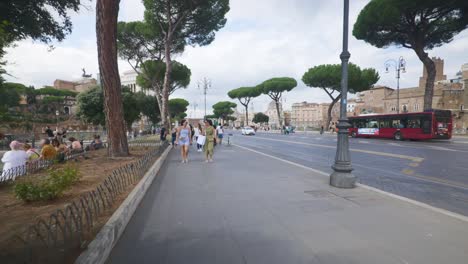 Rome-Immersive-POV:-Moving-In-Busy-Streets-to-Chiesa-Santi-Luca-e-Martina,-Italy,-Europe,-Walking,-Shaky,-4K-|-Busy-Sidewalk-As-Car-Passes