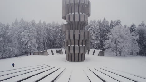 Aerial-view-of-Monument-to-the-Revolution-in-Kozara,-Bosnia-and-Herzegovina-in-the-foggy-winter