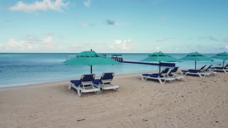 Orbit-shot-of-beach-chairs-and-umbrellas-during-a-bright-morning