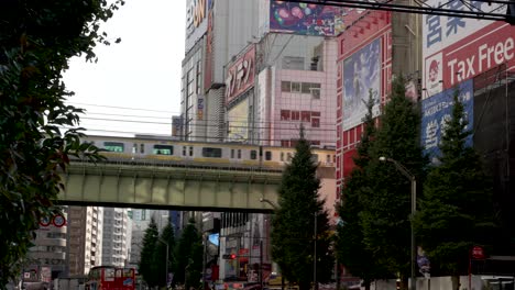 Train-traffic-at-elevated-train-track-in-Akihabara,-Tokyo,-Japan