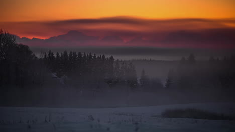 Colorful-timelapse-from-sunset-to-dark-over-foggy-snow-meadow