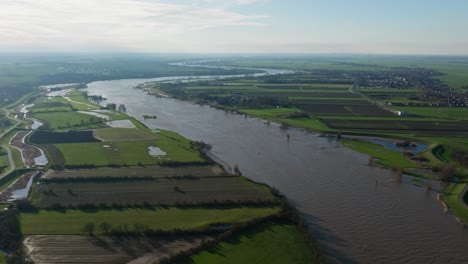 Swollen-Lek-river-with-flood-waters-in-countryside-after-heavy-rainfall