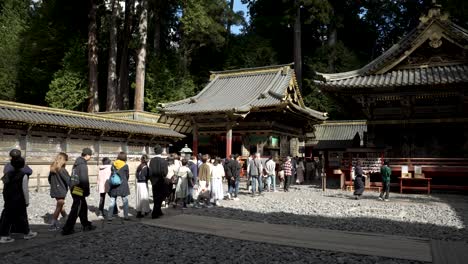 A-gradual-capture-of-people-moving-past-Honden,-Ishinoma,-and-Haiden-at-Nikko-Tosho-gu,-Japan