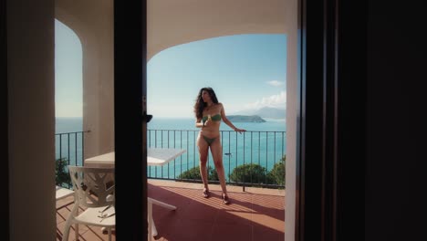 Woman-at-balcony-with-sea-view-San-Nicola-Arcella-Italy-summer-02