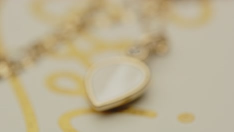 Extreme-close-up-of-a-beautiful-golden-locket-on-a-necklace-slowly-going-into-focus