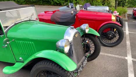 Three-classic-old-antique-racing-cars,-vintage-cars-at-a-parking-in-England,-expensive-collectible-cars,-single-seat,-4K-shot