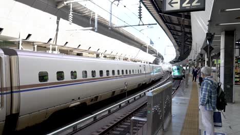 The-verdant-E5-and-H5-Series-Shinkansen-train-departing-platform-at-Tokyo-Station,-Japan