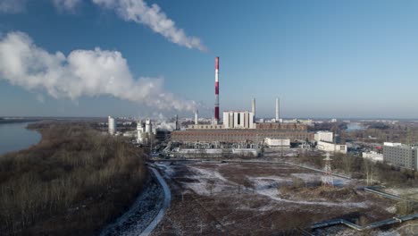 Aerial-Drone-Fly-approaching-Thermal-Power-Plant,-Smoking-Chimney-over-Skyline