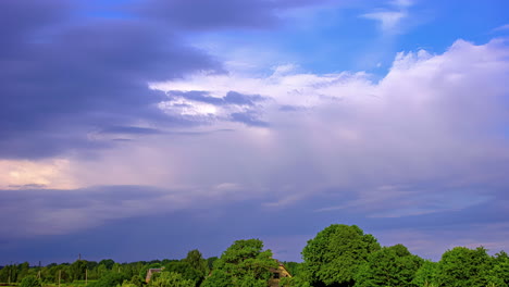 Colorful-timelapse-of-clouds-moving-over-a-green-forest-in-Europe-in-summertime