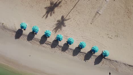 Drone-spinning-shot-of-beach-umbrellas