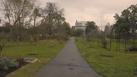 Pan-shot-of-Botanic-gardens-main-greenhouse-in-the-background-in-Dublin,-Ireland