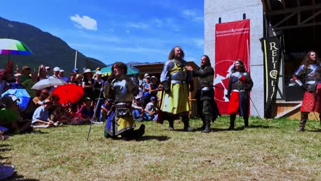 Comical-scene-with-knights-performed-by-Burdyri,-a-professional-sword-and-stage-combat-team,-during-the-South-Tyrolean-Medieval-Games-2023,-hand-held