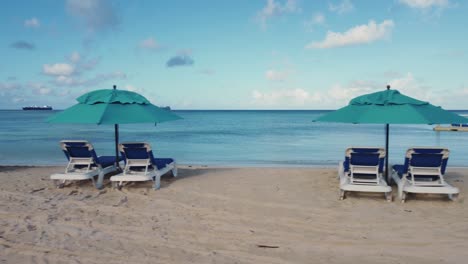 Pan-shot-of-beach-chairs-and-umbrellas-on-a-clear-day