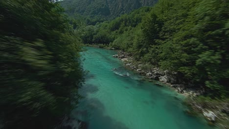 Aerial-View-Of-Soca-River-With-Emerald-Waters-Flowing-Through-Green-Forest-In-Slovenia
