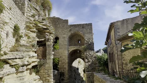 Ruin-with-stone-arch-passage-made-of-old-stones-in-France-in-good-weather-with-rock