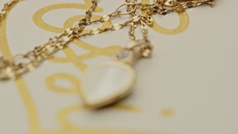 Focus-pull-to-a-beautiful-locket-decorated-with-diamonds-on-a-golden-chain