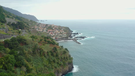 Seixal-Madeira-Coastline-drone-shot-with-waves-mountains-clouds-panoramic-Ocean-Horizon-with-cliffs-panorama-drone-shot
