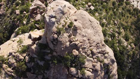 Aerial-top-down-shot-of-rocks-on-top-of-mountain-in-scenic-area-of-Taif---Nepal-during-sunny-day---rising-shot
