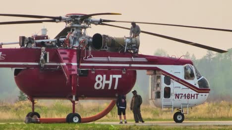 Mechanics-and-Technicians-Preparing-Firefighting-Helicopter-Before-Dispatch