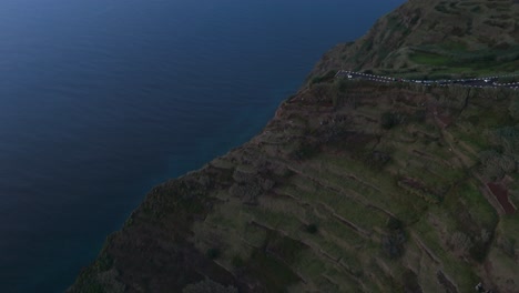 Clifftop-roadside-viewpoint,-dusk,-aerial-view