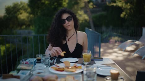 Mujer-Italiana-Con-Pelo-Rizado-Desayunando-Al-Aire-Libre-Al-Sur-De-Italia-Comiendo-Melocotón