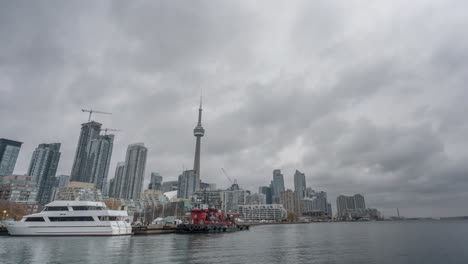 -Time-Lapse-shot-of-Harbour-front-with-a-cruise-ship-during-a-cloudy-evening-in-Toronto,-Canada