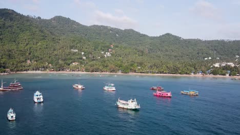 Aerial-View-Over-Moored-Boats-In-Gulf-Of-Thailand-With-Push-Forward-Shot-Towards-Sairee-Beach