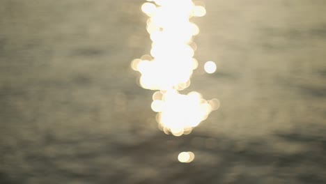 Blur-bokeh-effect-of-sunlight-falling-on-a-sea-with-waves-during-afternoon