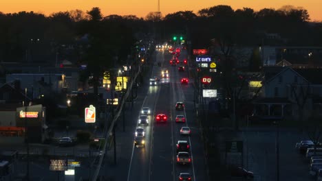 Twilight-over-a-busy-suburban-street-lined-with-glowing-storefront-signs