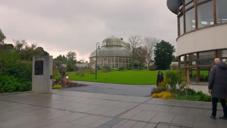 Cinematic-shot-of-National-Botanic-Gardens-with-some-visitors-in-a-cloudy-day-surrounded-with-greenery-during-winter-season-in-Dublin,-Ireland