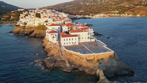 Aerial-drone-view-video-of-iconic-and-beautuful-Andros-island-chora,-Cyclades,-Greece-at-dusk