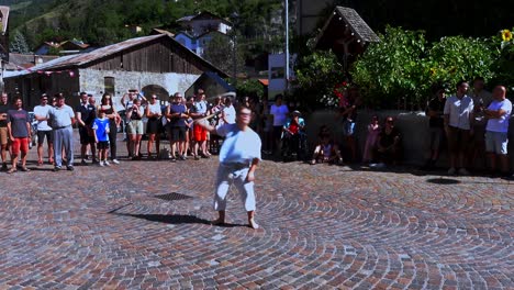 boy-cracking-the-whip-in-front-of-an-audience-at-the-South-Tyrolean-medieval-games-in-Schluderns---Sluderno,-Italy,-hand-held