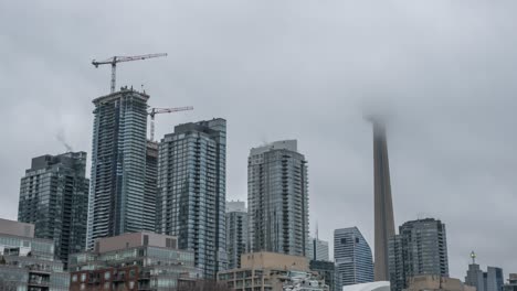 Time-Lapse-zoom-out-shot-of-beautiful-skyline-of-Downtown-during-a-foggy-morning-in-Toronto,-Canada