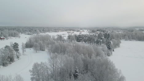 Remote-Rural-settlement-and-Scenic-Northern-Landscape-in-crisp-frozen-Winter-weather,-aerial-view