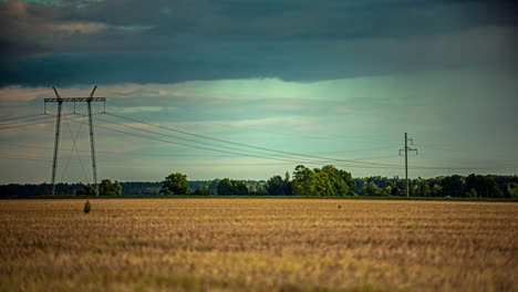 Timelapse-of-rain-showers-moving-in-the-background-of-electricity-pylons-in-Latvia