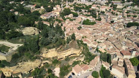 Wide-aerial-view-of-neighborhood-in-Cadenet-in-Provence,-France-on-a-partly-cloudy-summer-day