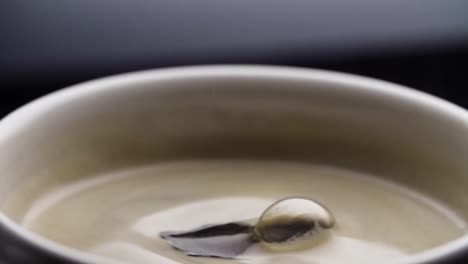 Black-coffee-drop-into-the-filled-Cup-from-the-coffee-machine-in-slow-motion