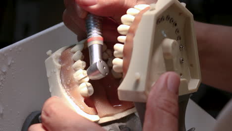 Dentist-Dental-Turbine-Practicing-on-a-Dental-Training-Model,-Close-Up