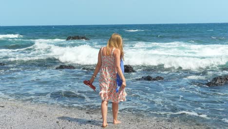 Gorgeous-blonde-enjoys-warm-Atlantic-ocean-in-Tenerife-island,-back-view