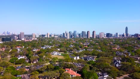 An-aerial-suburban-view-with-a-skyline-behind-it,-at-60-frames