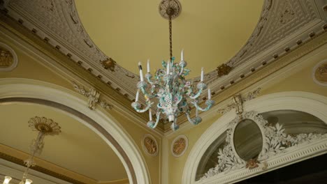 Chandelier-Under-Decorated-Ceiling-In-The-Interior---Low-Angle-Shot