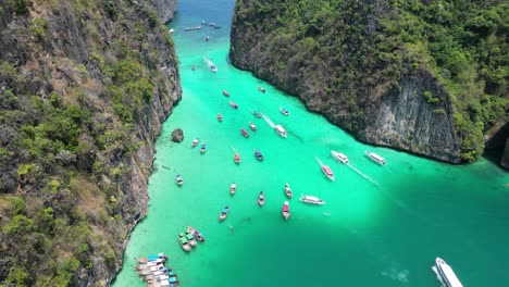 Boats-in-vibrant-Pileh-Lagoon-of-Phi-phi-island-on-sunny-day,-Aerial