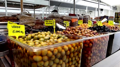 Different-types-of-olives-from-Portugal-on-sale-in-Bolhao-Market,-motion-view
