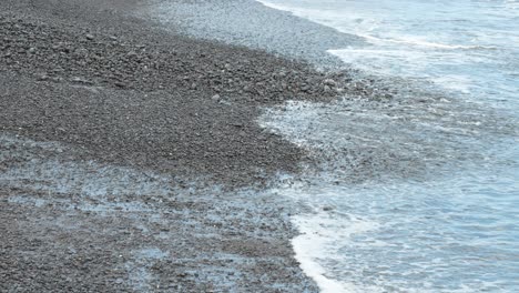 Atlantic-ocean-waves-washing-small-pebbles-on-Tenerife-beach