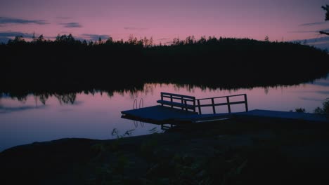 Swimming-pier-in-Swedish-lake-during-pink-sunset