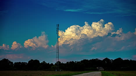 Time-lapse-of-fluffy-white-clouds-passing-behind-a-cell-tower