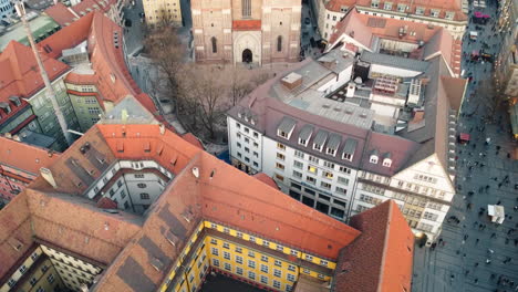 Revealing-aerial-of-the-Munich-Frauenkirche,-or-the-Cathedral-of-Our-Dear-Lady,-a-prominent-landmark-and-iconic-symbol-of-Munich,-Germany