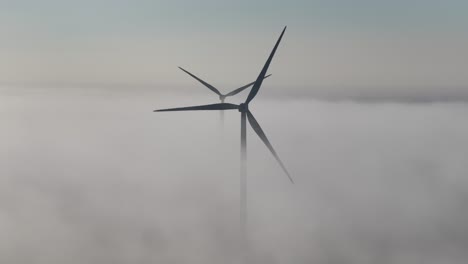 Aerial-above-the-fog-on-a-wind-farm-at-dawn